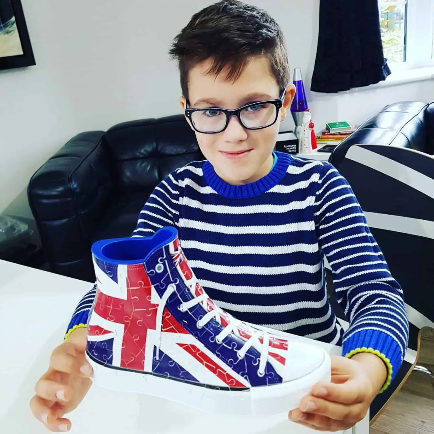 young boy completing a 3d puzzle