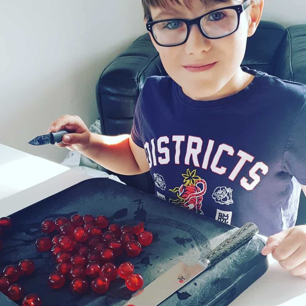 Boy chopping Cherries