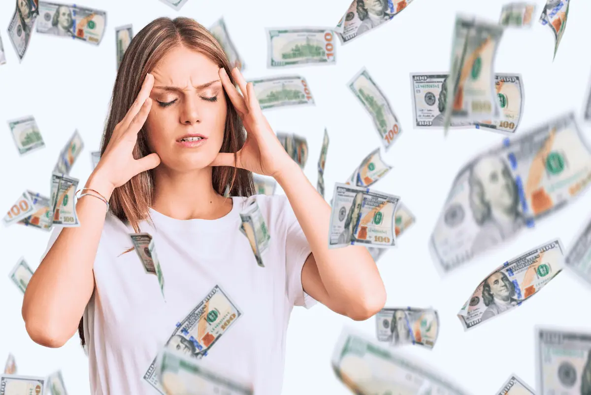 A woman holding her head with dollar bills floating around, illustrating the financial concerns of homeschooling.