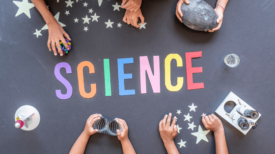 Black screen with kids hands playing with stars and rocks with the word science in the middle. 