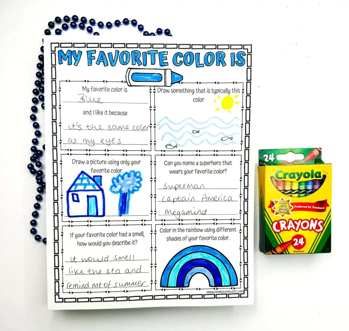 Printable worksheet for children titled 'My Favorite Color Is,' filled with blue crayon. It features a blue house drawing, superheroes associated with blue such as Superman and Captain America, and a blue-scented description reminiscent of the sea and summer.