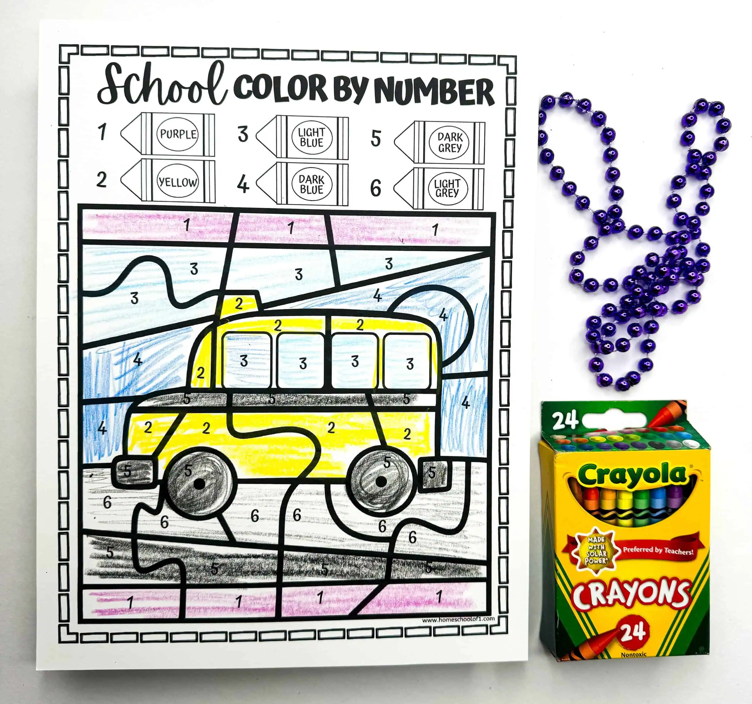 A color by number activity sheet with a brightly colored school bus against a blue background. The beads are arranged in a rabbit shape, and a Crayola crayon box is also shown, suggesting this as a coloring task for children.