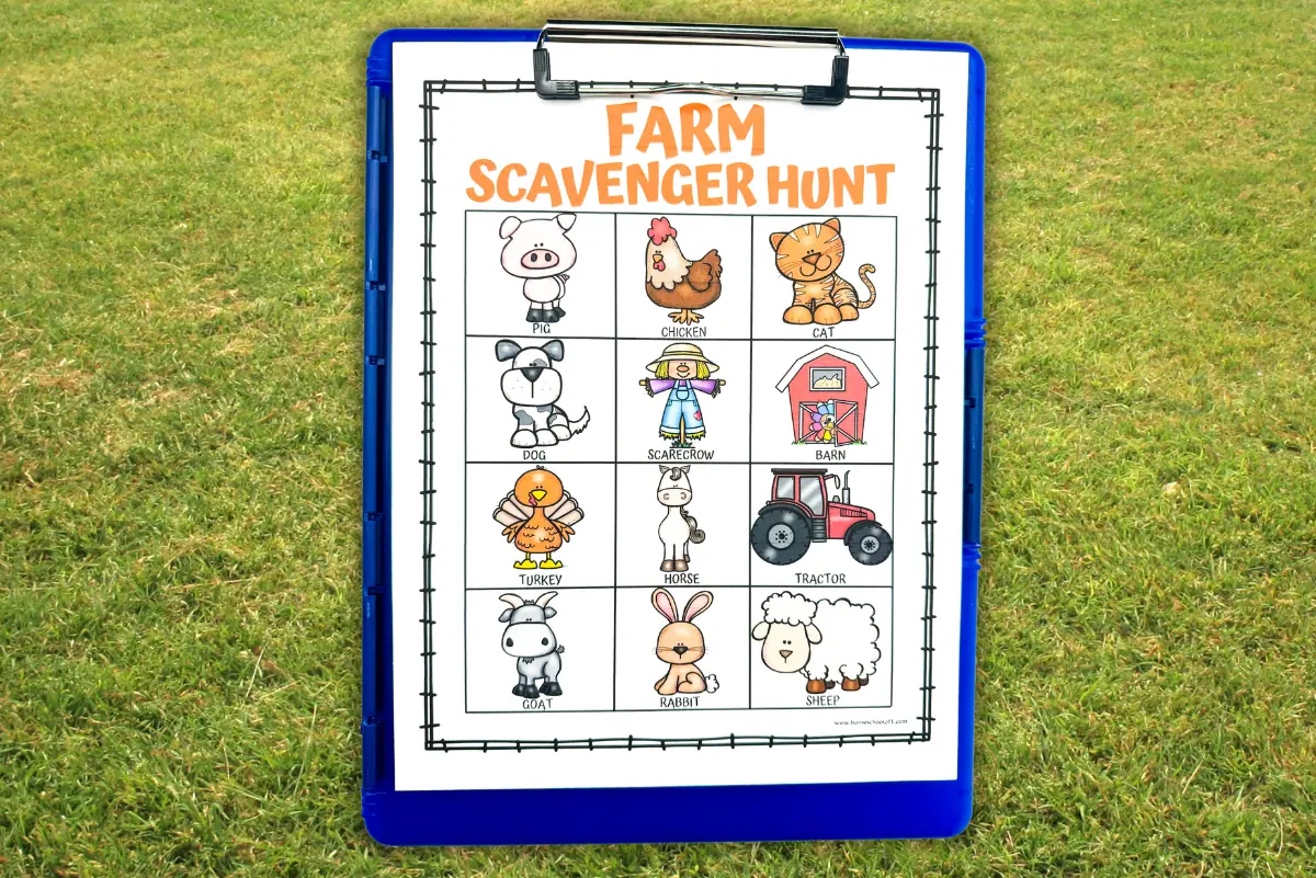 Clipboard with 'Farm Scavenger Hunt' free printable on a grassy field, showcasing cartoon farm animals and farm-related items for kids to find, with clear visibility for outdoor educational activities.