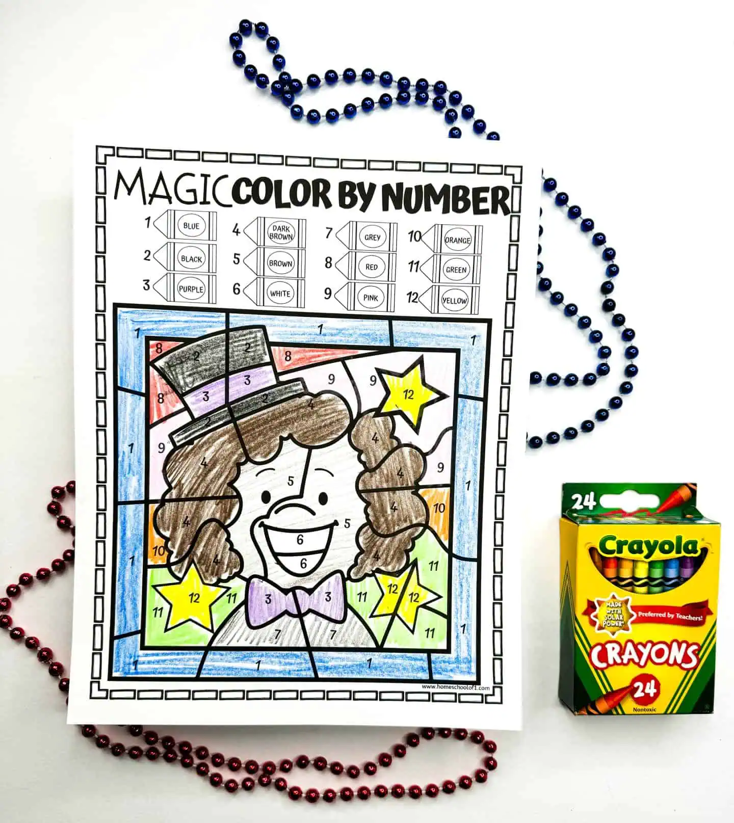 A color by number art piece showing a cheery magician with a purple hat and green bow tie, accompanied by a Crayola crayon box and red and blue beads.