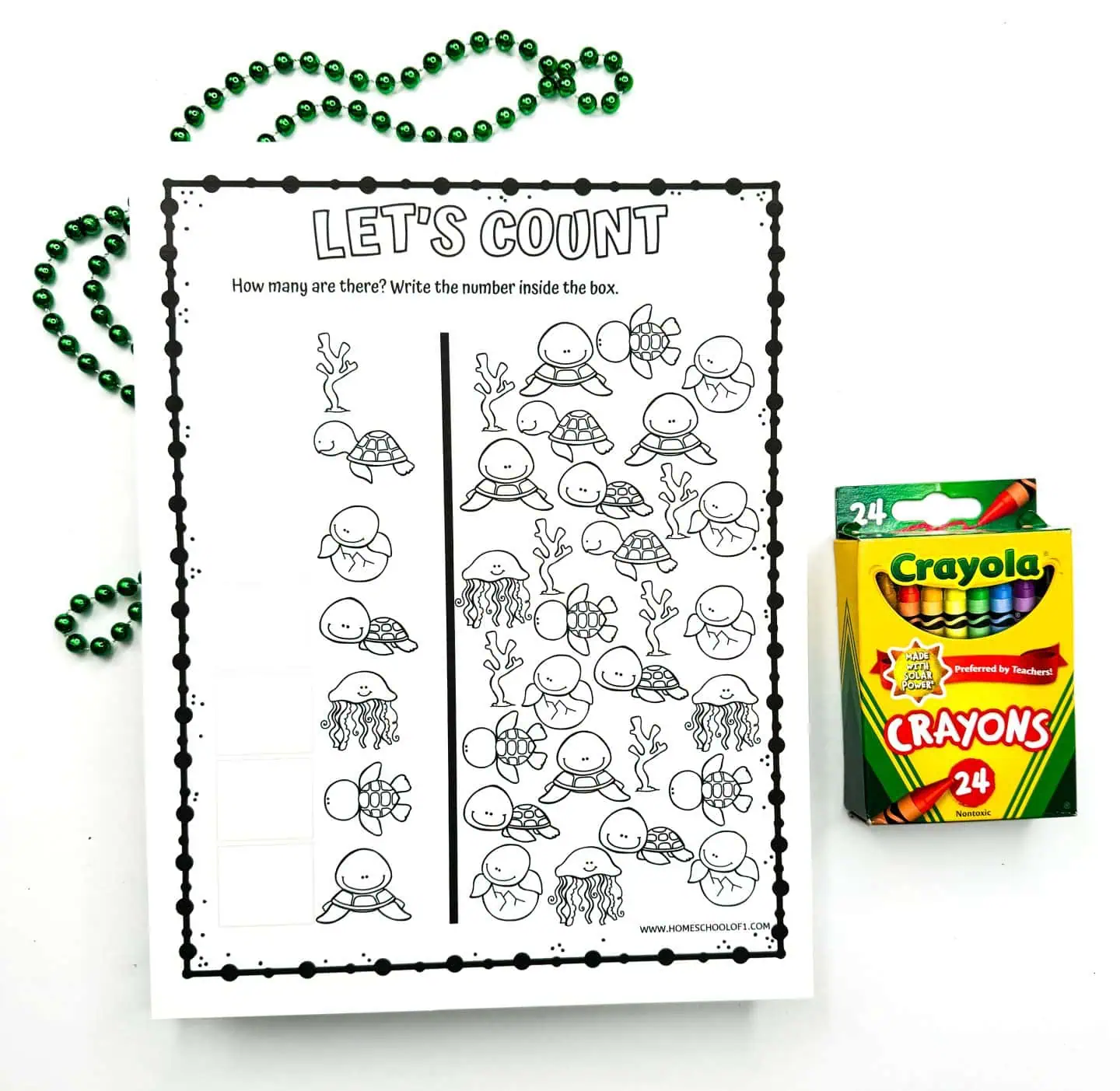 Educational activity sheet titled 'LET'S COUNT' with various sea creatures including turtles, jellyfish, and seaweeds to be counted by children, with a space to write numbers. Crayola crayons and beads are visible on the side.