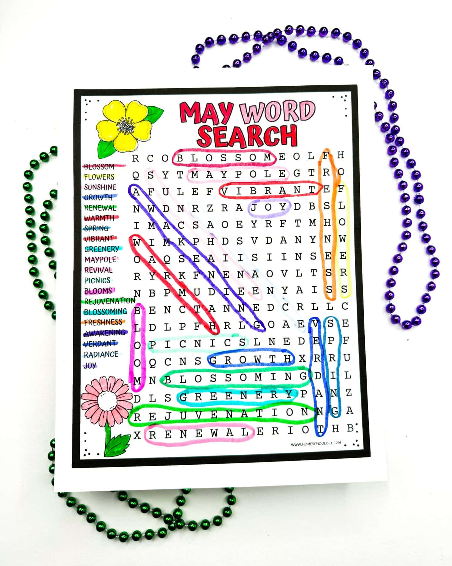 "May Word Search puzzle with words like 'blossom', 'vibrant', and 'greenery' circled in colorful lines, bordered by illustrations of spring flowers and framed by Mardi Gras necklaces