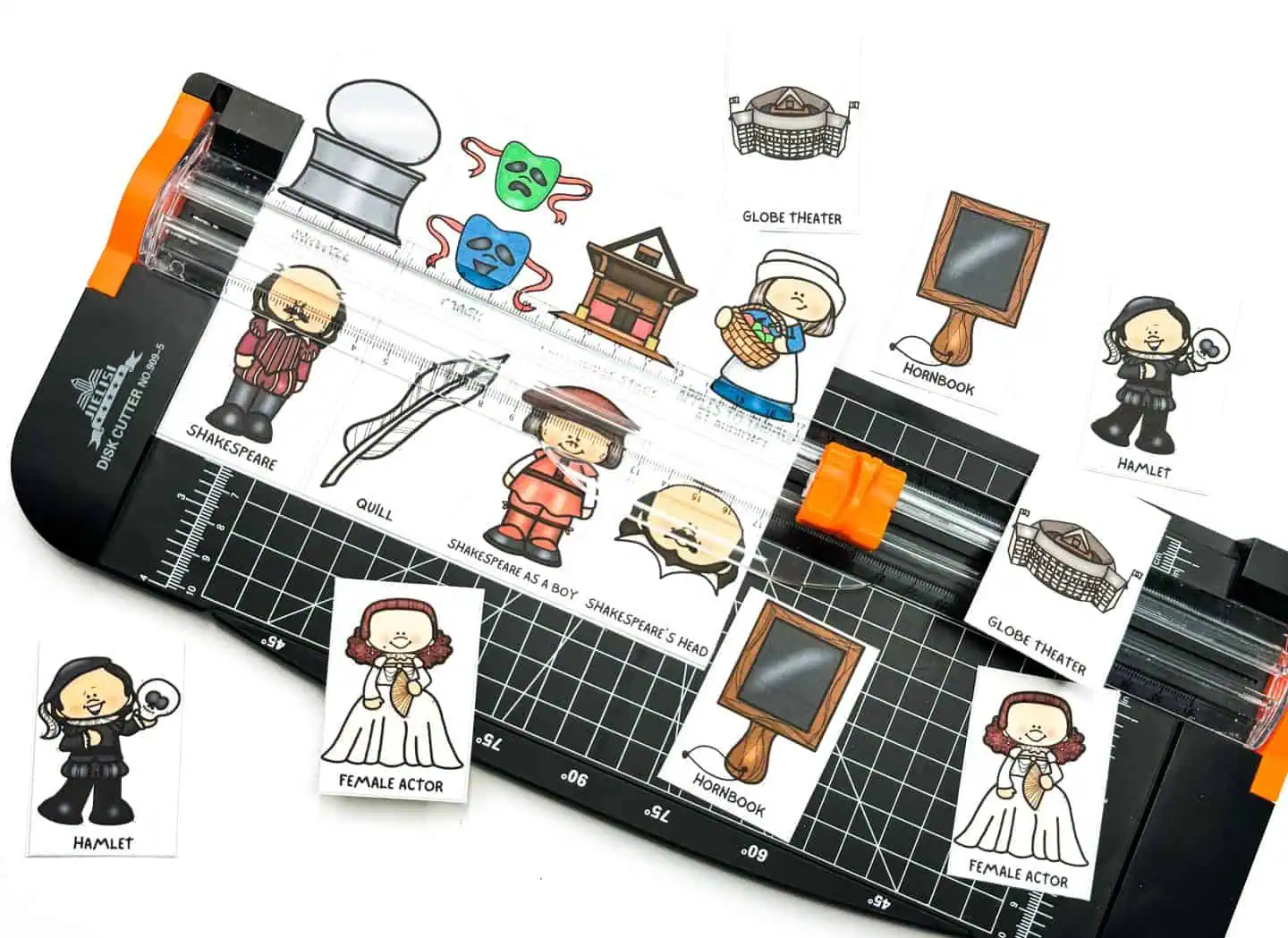 Cutting out 'Shakespeare Memory Game' cards, featuring illustrations like Shakespeare, a quill, the Globe Theater, and a mask, with tools such as scissors and a paper cutter.