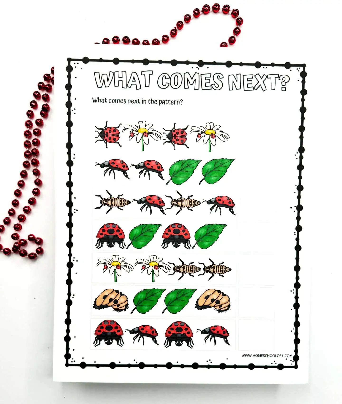 Printable 'What Comes Next?' pattern recognition worksheet, displaying colored sequences of ladybugs, leaves, flowers, and larvae for children to determine the next in sequence, embellished with red beads