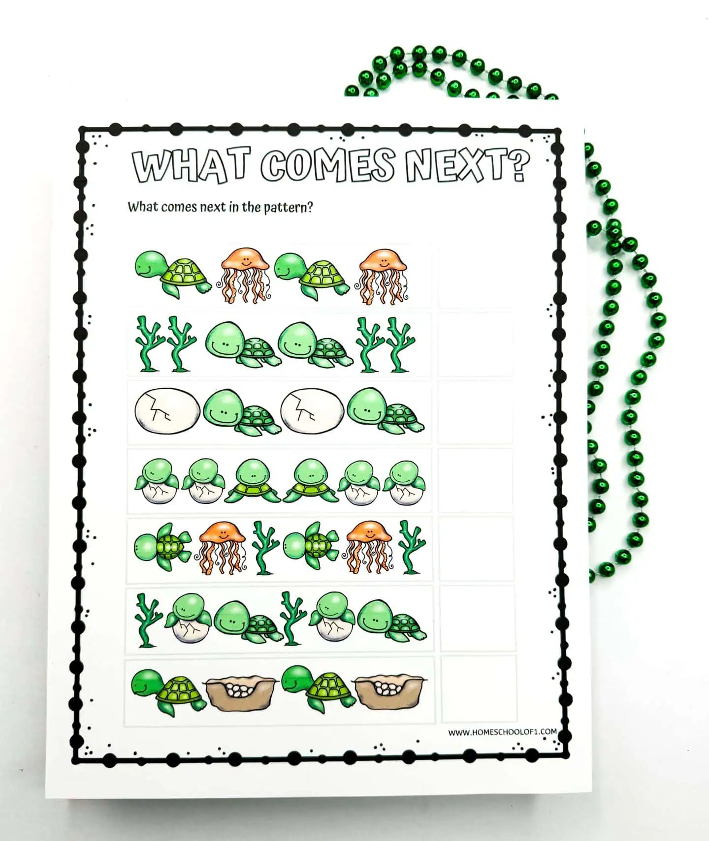 Worksheet for children named 'WHAT COMES NEXT?' to determine the next item in a pattern sequence using illustrations of turtles, jellyfish, and seaweed. Green beads and a Crayola crayon box are also shown.