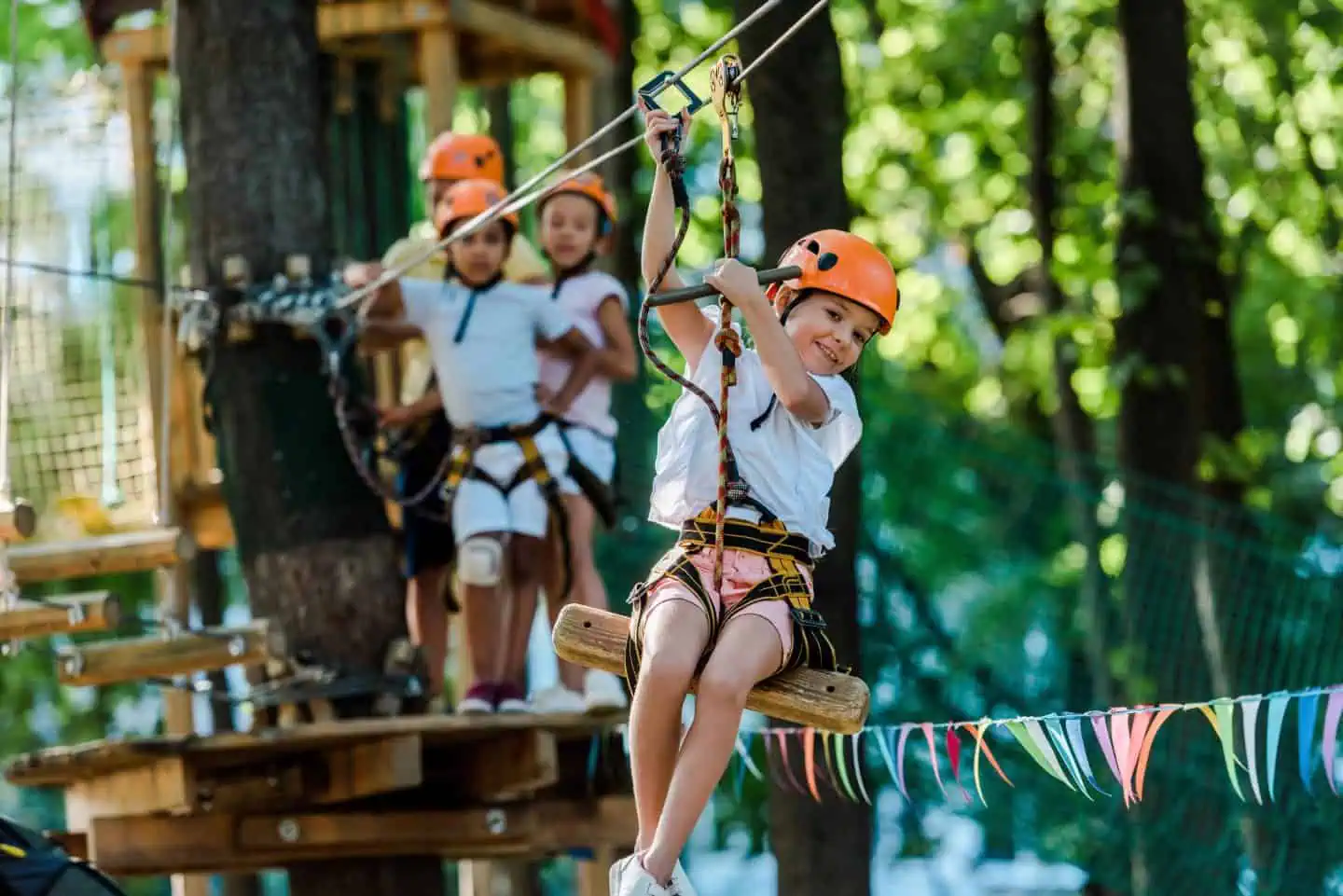 Child enjoying a zipline adventure at a summer camp, showcasing outdoor activities and summer learning experiences.